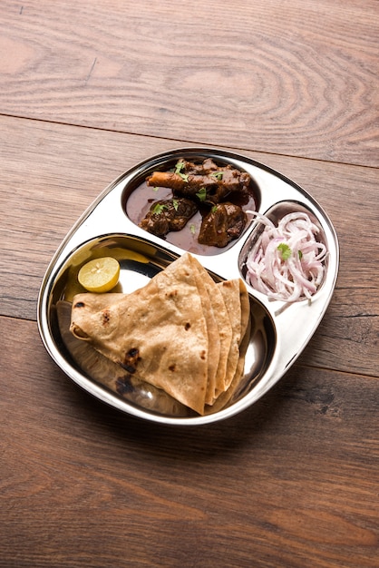 Motton Thali OR Gosht, Lamb platter is Indian asian non veg lunch or dinner menu consists of meat, egg curry with chapati ,rice, salad and sweet Gulab Jamun