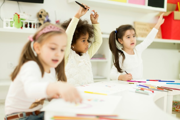 Multiracial children drawing in the playroom