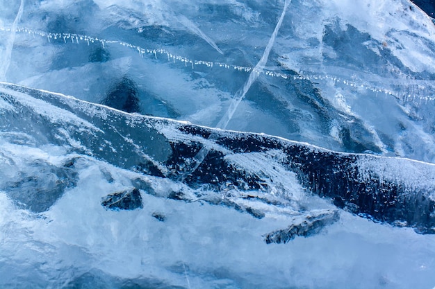 Photo natural ice texture with cracks and air bubbles thick blue transparent ice horizontal