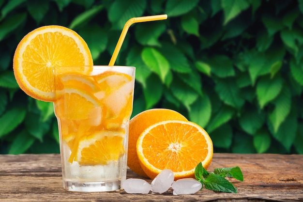 Natural lemonade with mint and fresh oranges on wooden table