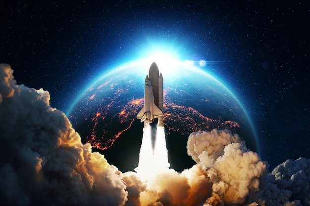 New space rocket lift off. Space shuttle with smoke and blast takes off into space on a background of blue planet earth with amazing sunset. Successful start of a space mission. Travel to Mars