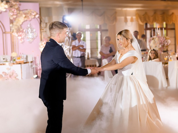 Newlyweds Holding Hands While Dancing