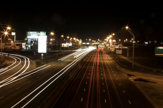 Night avenue of a big city with blurred car red and white lights