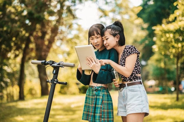 Photo online. two girls watching photos online and looking involved