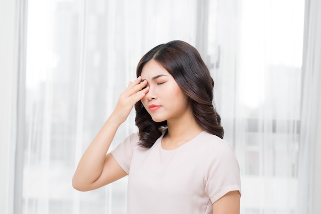 Pain. Tired Exhausted Stressed Woman Suffering From Strong Eye Pain. Portrait Of Beautiful Young Female Feeling Sick, Having Headache, Nose Pain And Touching Painful Eyes. Healthcare. High Resolution