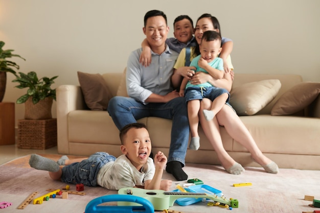 Parents and Children Hugging on Sofa