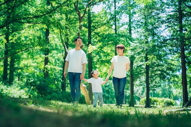 Parents and their child exploring the woods