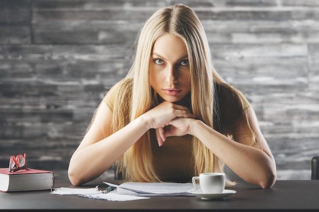 Pensive woman doing paperwork