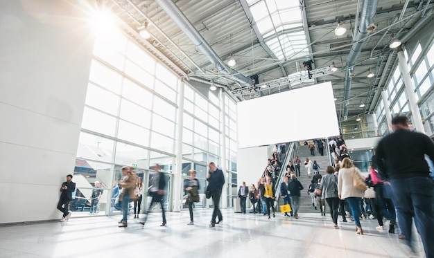 Photo people rushing at a entrance at a trade fair, including banner with copy space. ideal for websites and magazines layouts