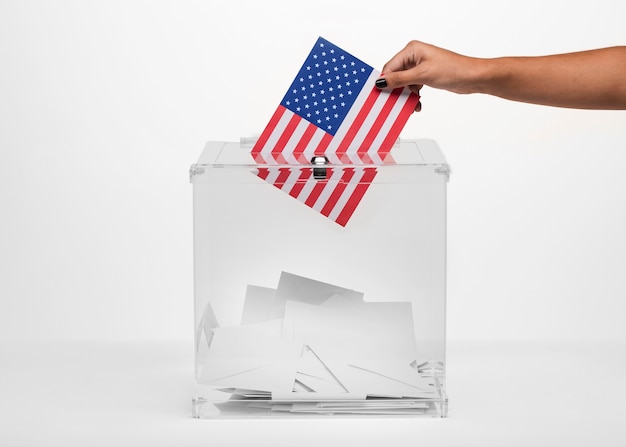 Person putting an american vote in ballot box