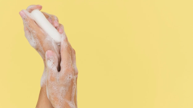 Person washing hands with soap