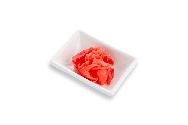 Pickled ginger root in a white rectangular gravy boat. Seasoning for sushi. White background. Isolated.