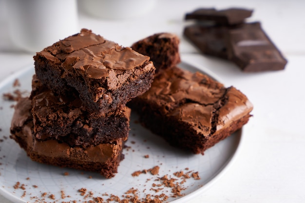 Pieces of brownie cake served on a white table Chocolate cake