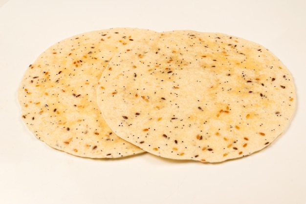 Pitta bread with seeds isolated on white