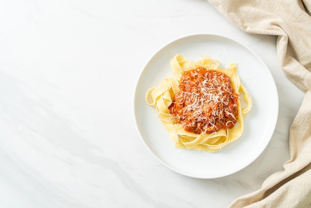 pork bolognese fettuccine pasta with parmesan cheese - Italian food style