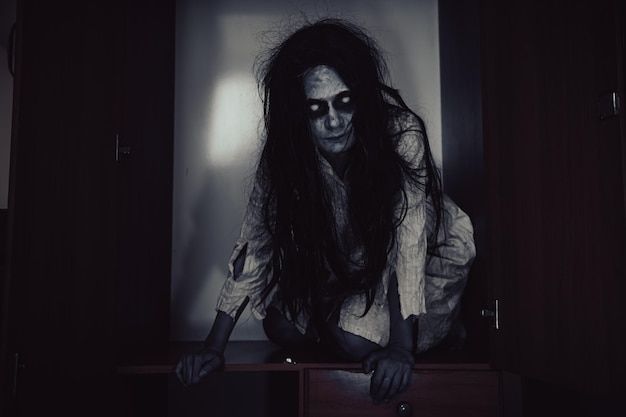 Photo portrait of asian woman make up ghostscary horror scene for backgroundhalloween festival conceptghost movies posterangry spirit in the apartment