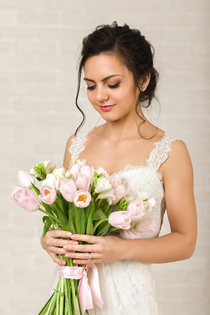 Portrait of beautiful bride with wedding bouquet