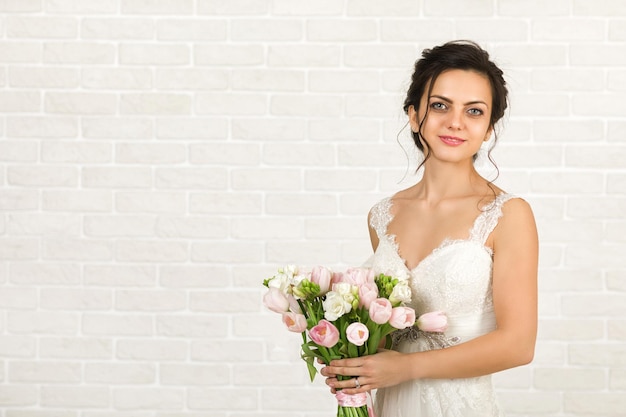 Portrait of beautiful bride with wedding bouquet