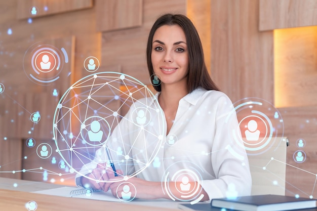 Portrait of smiling businesswoman in formal wear looking for employees and thinking how to hire new candidates for international business consulting HR networking icons over office background