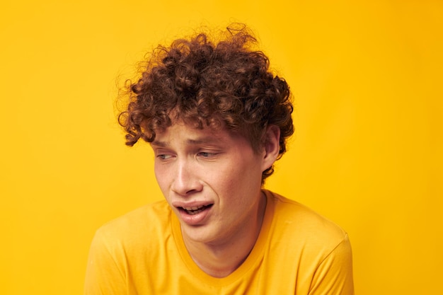 Portrait of young man against yellow background