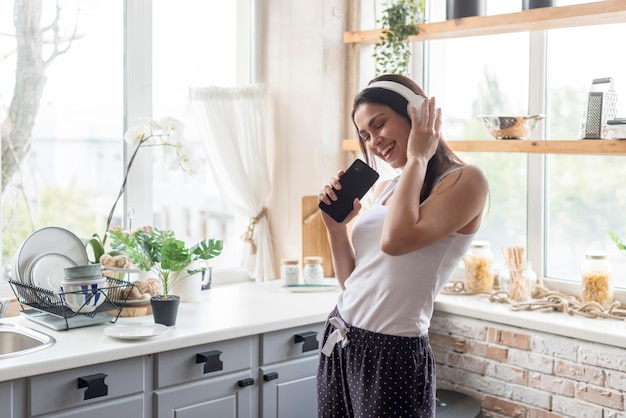 Positive young woman listening to music