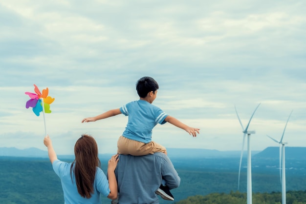 Photo progressive happy family enjoy their time at wind farm for green energy concept