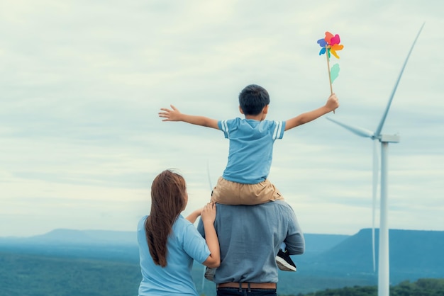 Photo progressive happy family enjoy their time at wind farm for green energy concept