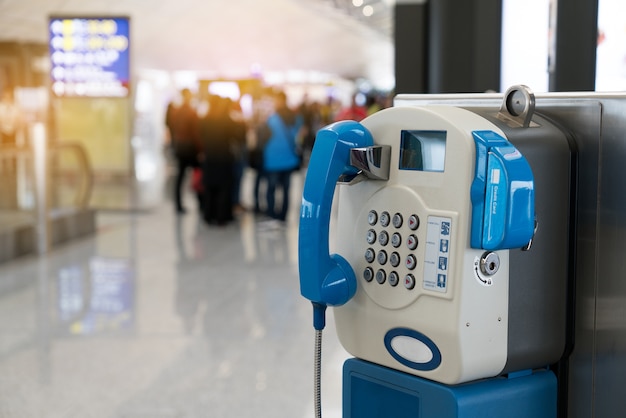 Public payphone telephone inside the international airport.