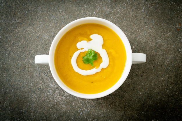 pumpkin soup in white bowl - Vegetarian and vegan food style