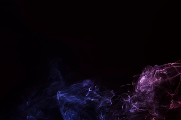 Purple and pink smoke fragments on a black background