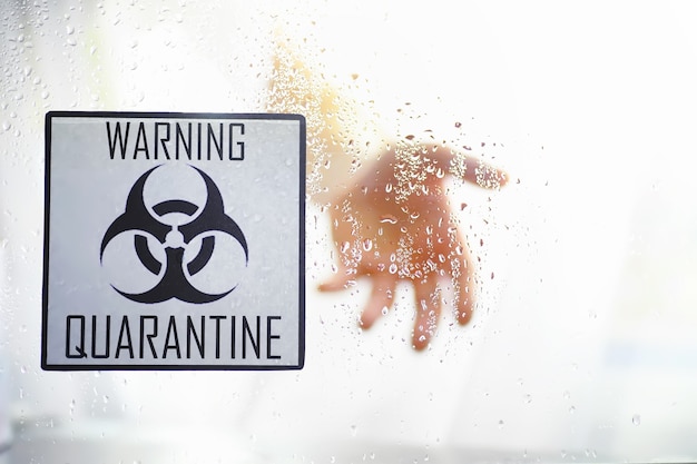 Quarantine. Quarantine warning sign on a glass door in a hospital isolator. Isolation of patients with the virus in special laboratories. Virus.