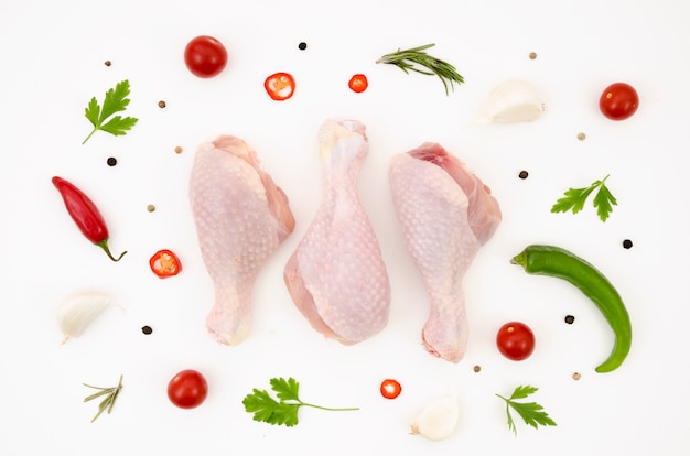 Raw chicken parts with different ingredients