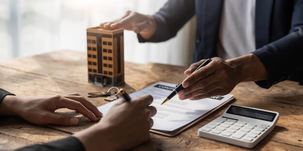 Photo real estate agent talked about the terms of the home purchase agreement and asked the customer to sign the documents to make the contract legally home sales and home insurance concept