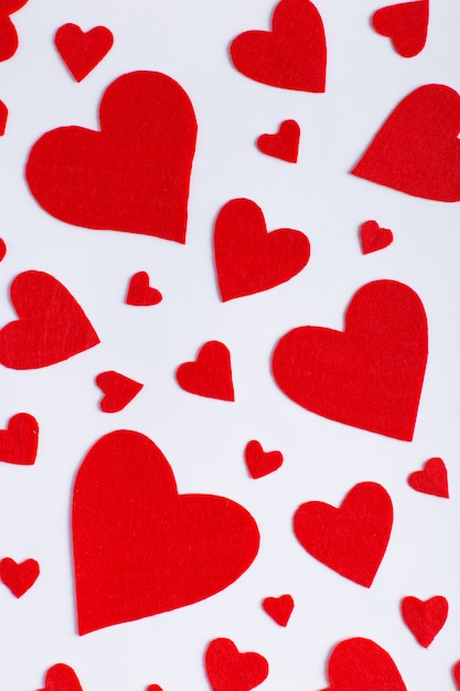 Red hearts of different sizes on a white background