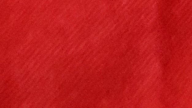 Photo red textured surface with subtle shade variations or uniform red color dominating the frame