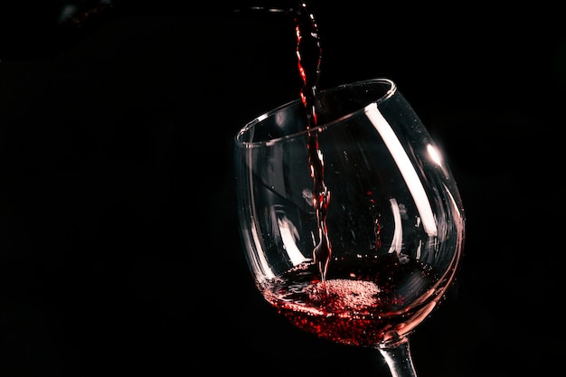 Red wine pouring into glass