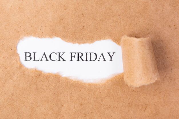 Photo ripped paper revealing black friday text