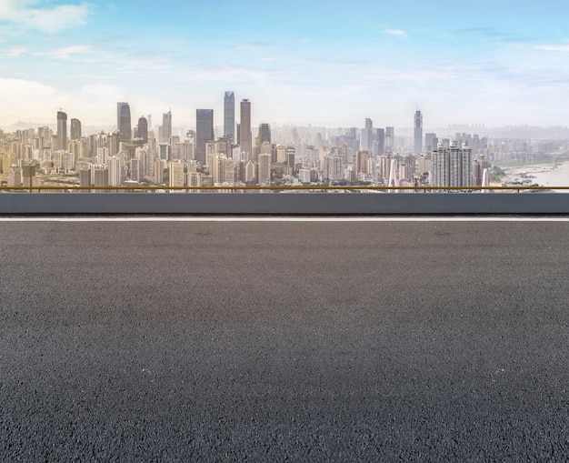 Road pavement and city skyline