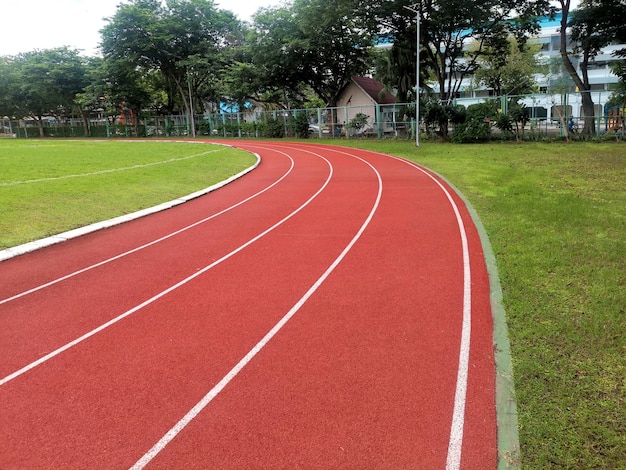 Photo the running track inside a football stadium is usually a circular pathway surrounding the field