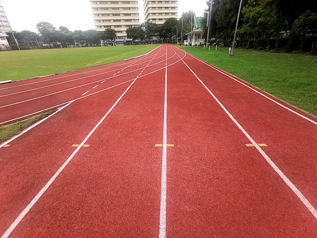 Photo the running track inside a football stadium is usually a circular pathway surrounding the field