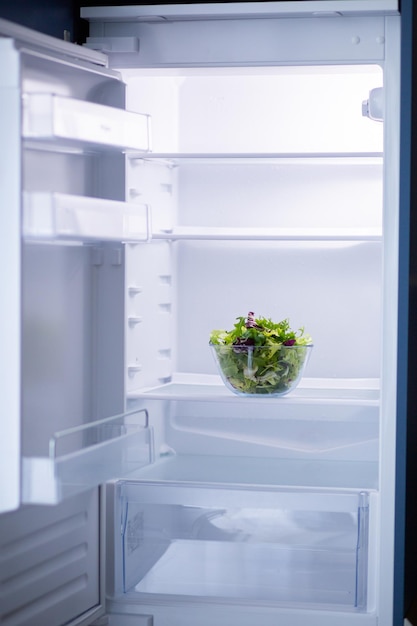 Salad in a transparent bowl in the refrigerator Food for vegetarians Set of different salads