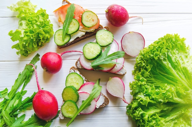 Sandwiches of wheat brown bread with cucumbers and radish 