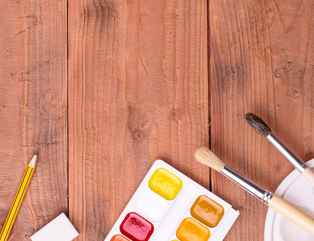 Photo school and painter accessories on wooden table