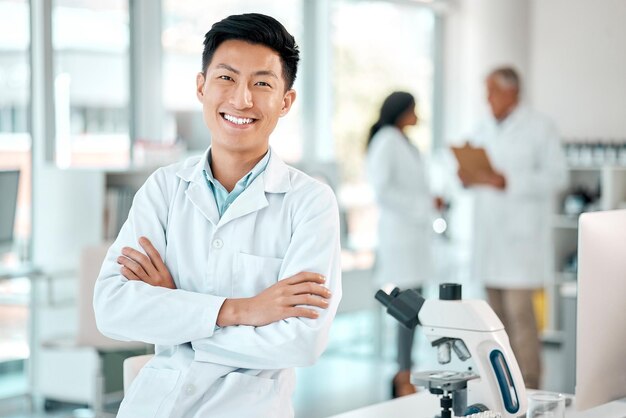 Photo scientist portrait and asian man with arms crossed in lab for innovation research or investigation cure pathology and person with confidence for discovery breakthrough or medical experiment