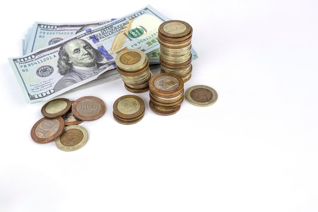 Selective focus of coins stacks and dollar banknotes on white background