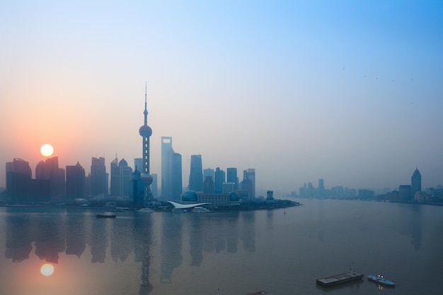 Shanghai skyline and reflection in sunrise