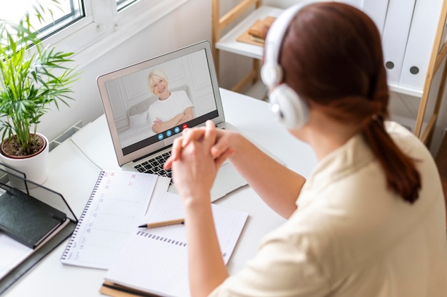 Photo side view woman making a video call