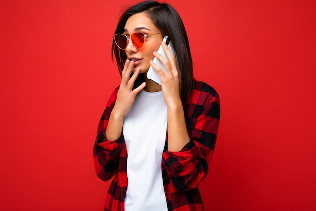 Sideprofile photo of beautiful young brunette woman wearing stylish red shirt white tshirt and red