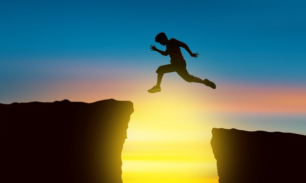 Photo the silhouette of a man jumping over the abyss at the time of the sun set, concept of victory and success