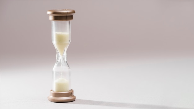 Simple and elegant sand-glass timer against colored background